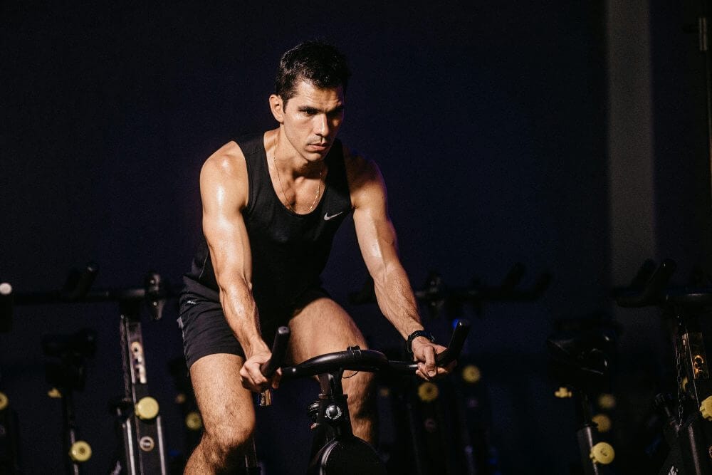 Man on a bicycle in the gym.