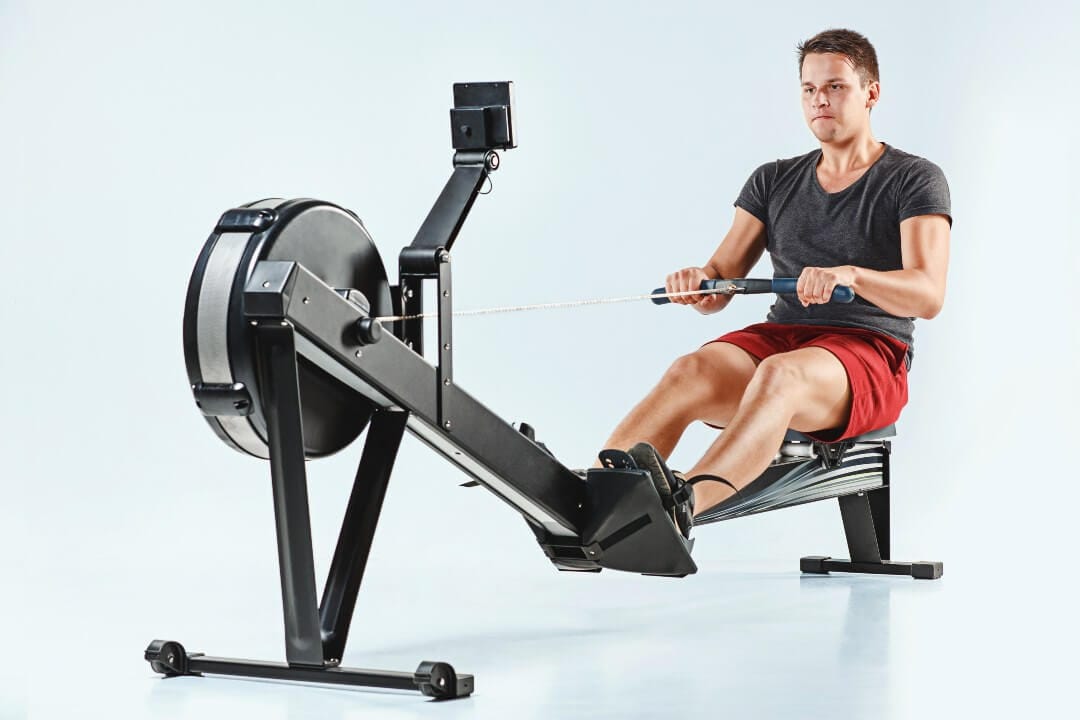 Man using rowing machine.